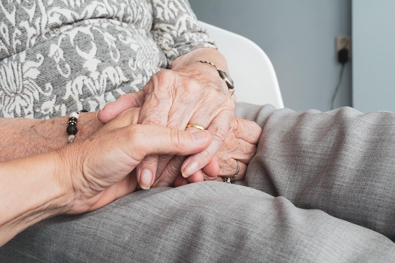 elderly couple holding hands considering whether life insurance in Oakville is worth it