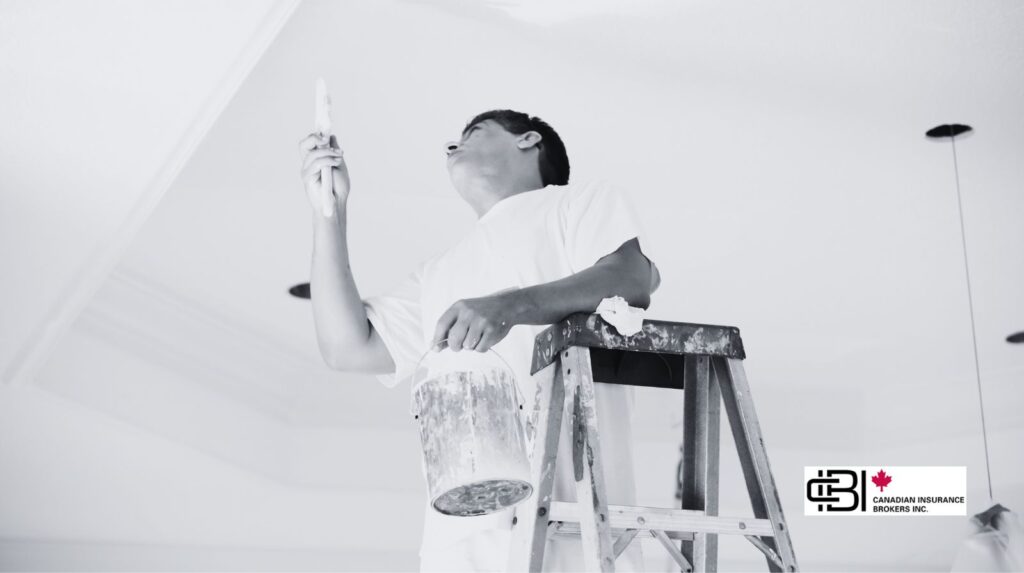 Professional painter on a ladder applying paint to a ceiling, representing insured painting contractors in Oakville.