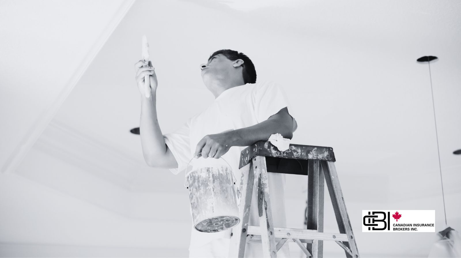 Professional painter on a ladder applying paint to a ceiling, representing insured painting contractors in Oakville.
