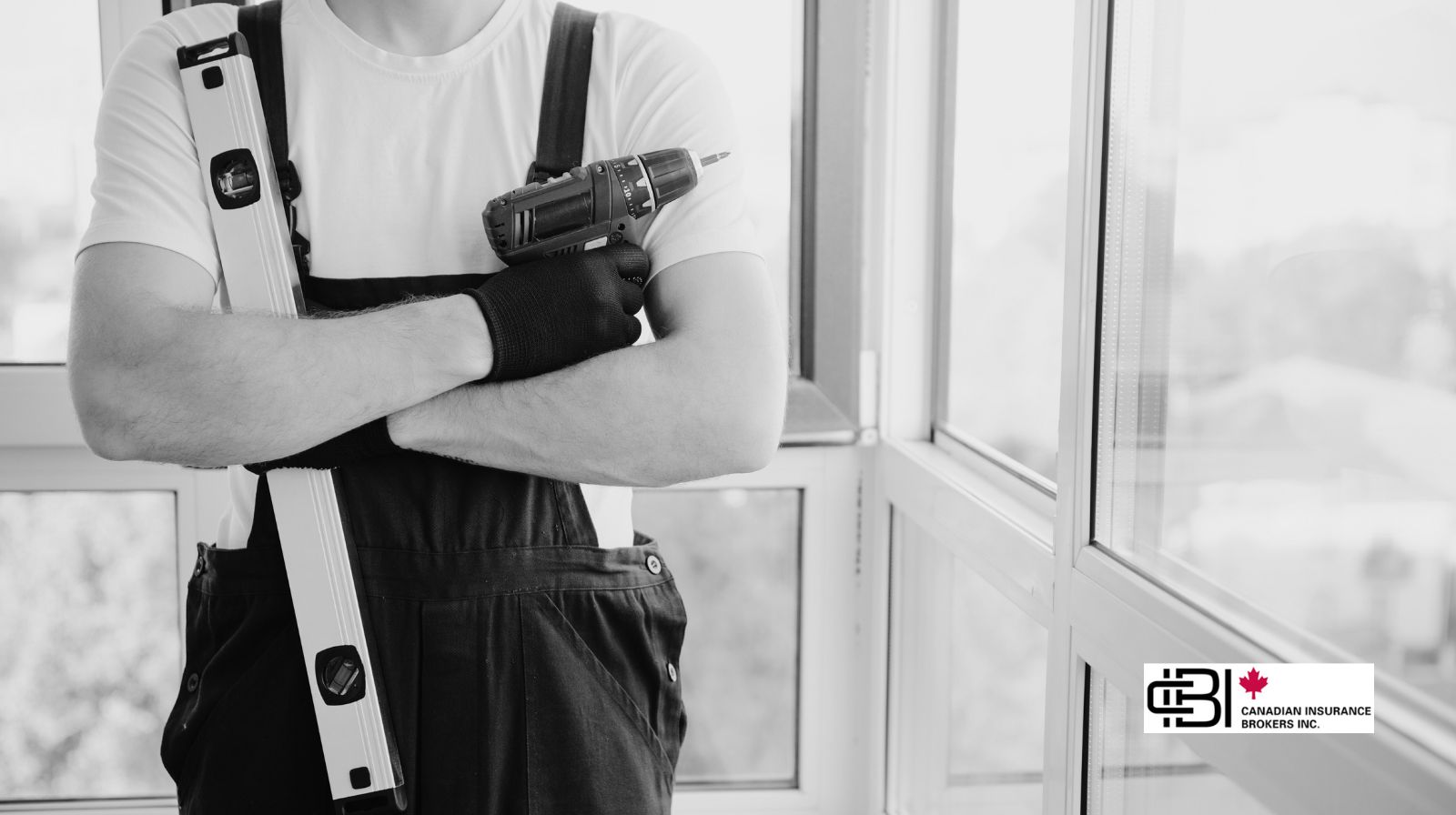 Window and door installer holding a drill and level inside a residential property in Oakville, Ontario