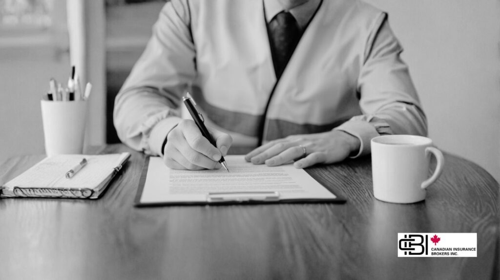 Man signing commercial general liability insurance documents in Oakville