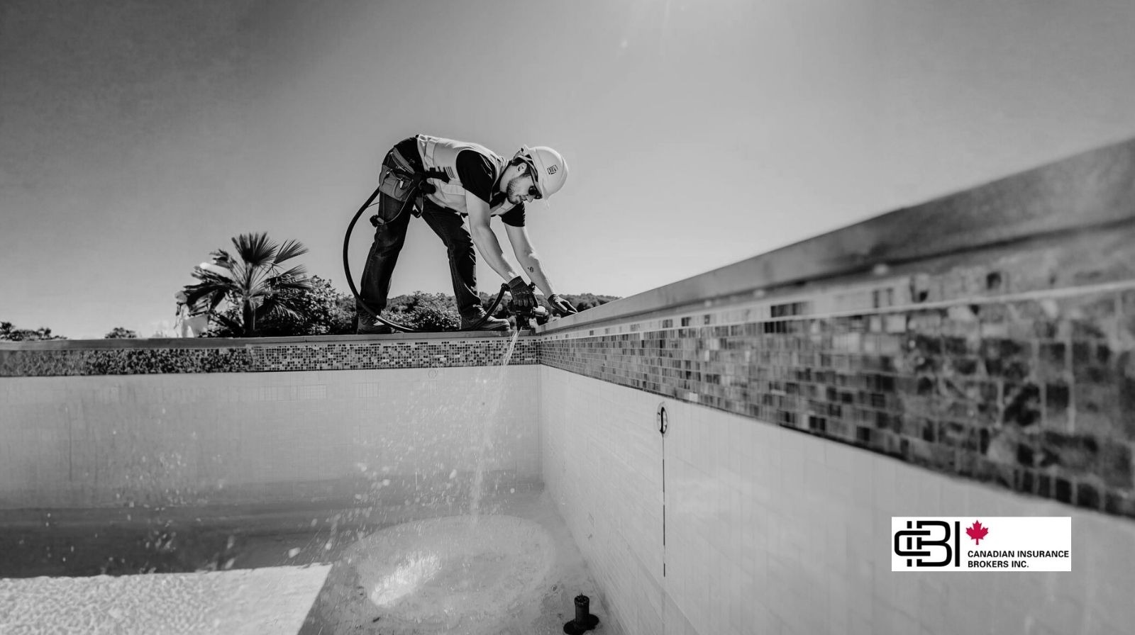 Residential pool construction site with excavation equipment and unfinished concrete shell