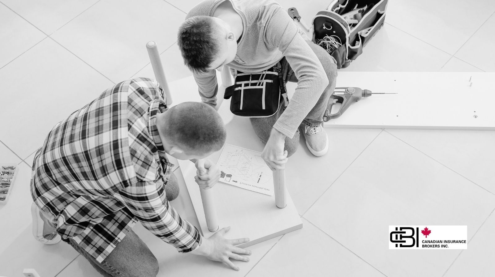 Two handymen assembling furniture indoors during a residential service job in Ontario