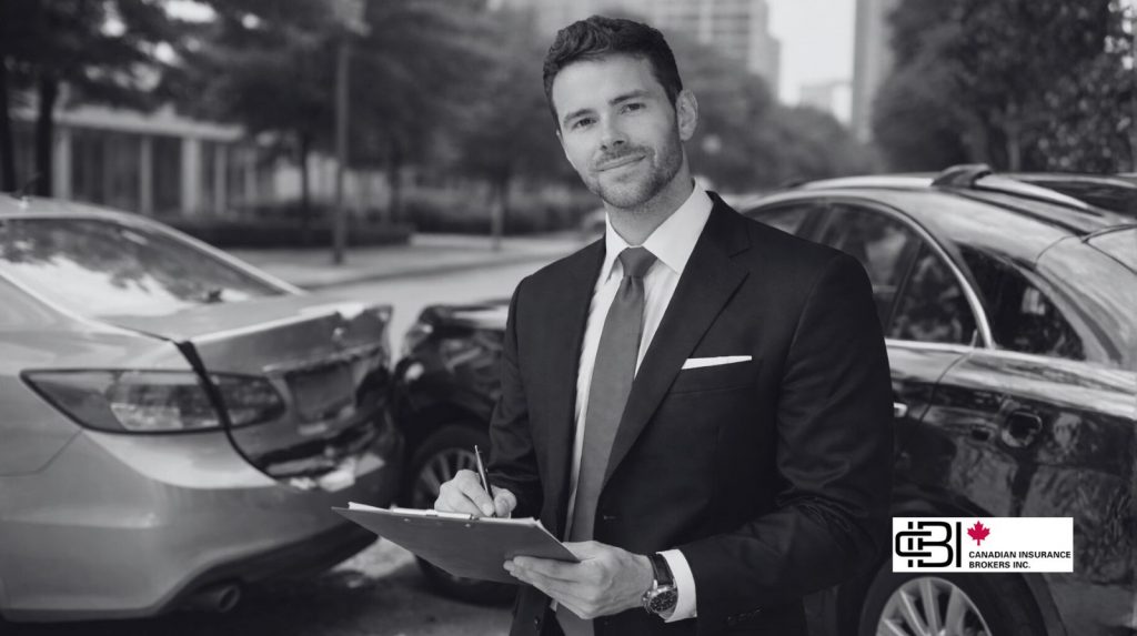James Inwood reviewing accident details near damaged vehicles