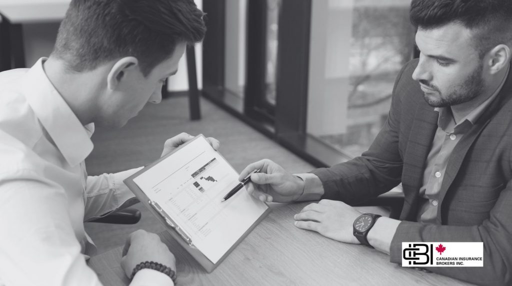Professionals reviewing financial data on a tablet during a meeting about How To Start a Consulting Business