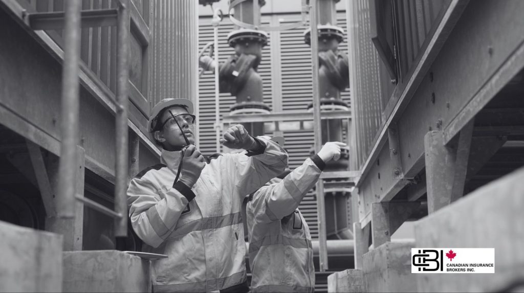 Industrial workers inspecting machinery in a plant, representing equipment breakdown insurance for maintenance and operational risk management.