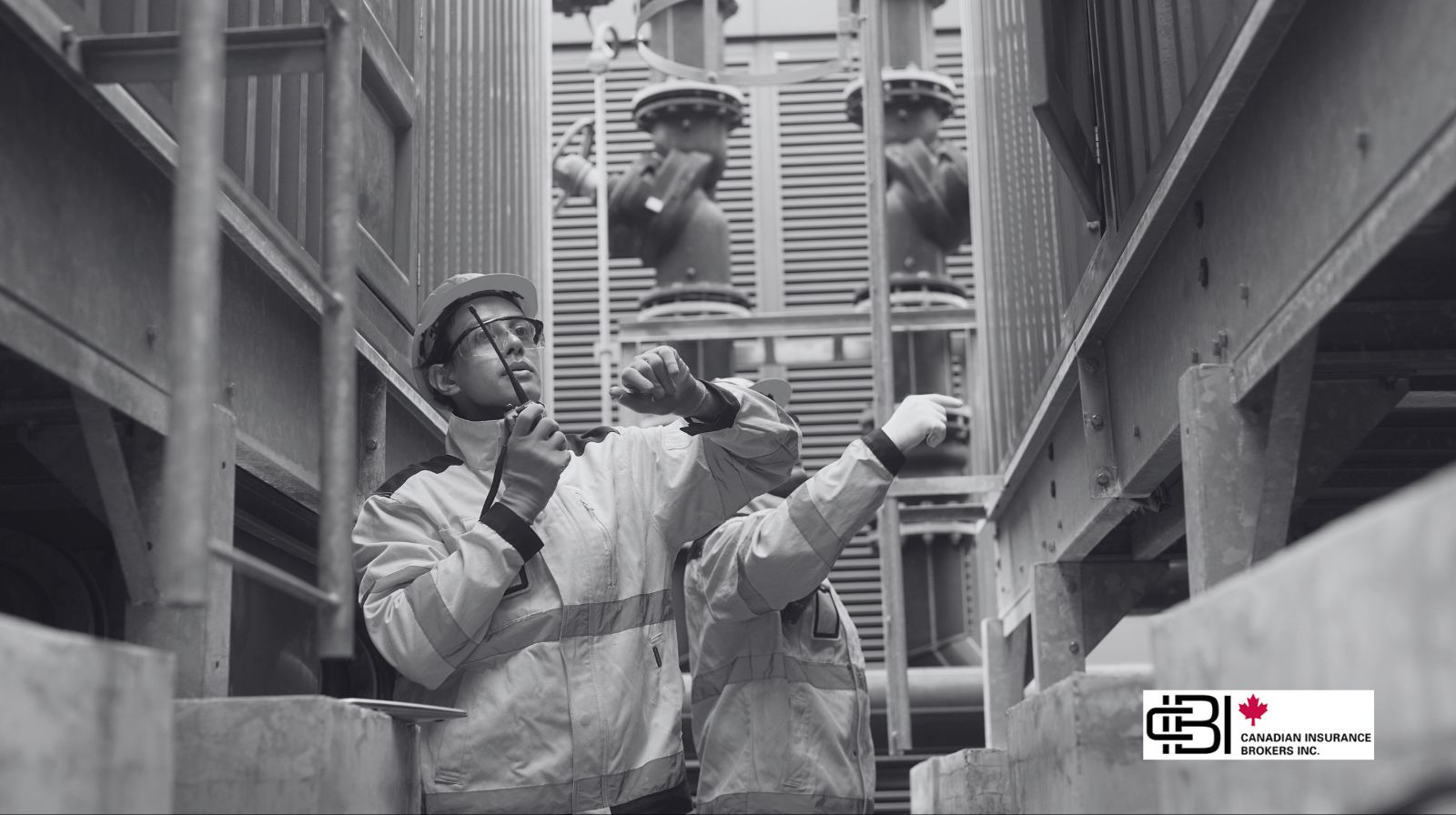 Industrial workers inspecting machinery in a plant, representing equipment breakdown insurance for maintenance and operational risk management.