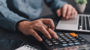 Accountant calculating financial figures at a desk, representing professional accountant insurance coverage