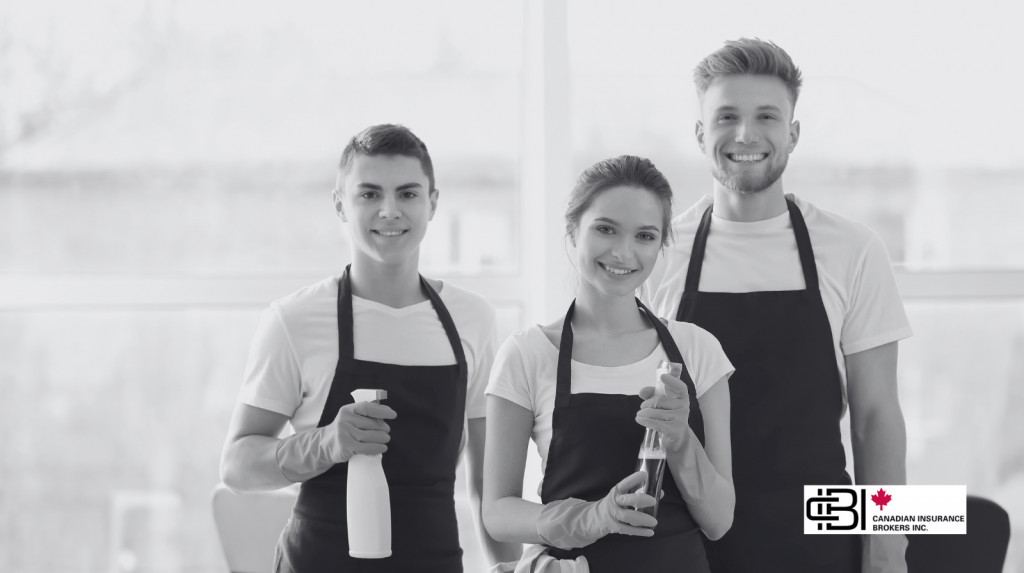 Smiling cleaning team holding supplies, representing small companies that need cleaning business insurance coverage