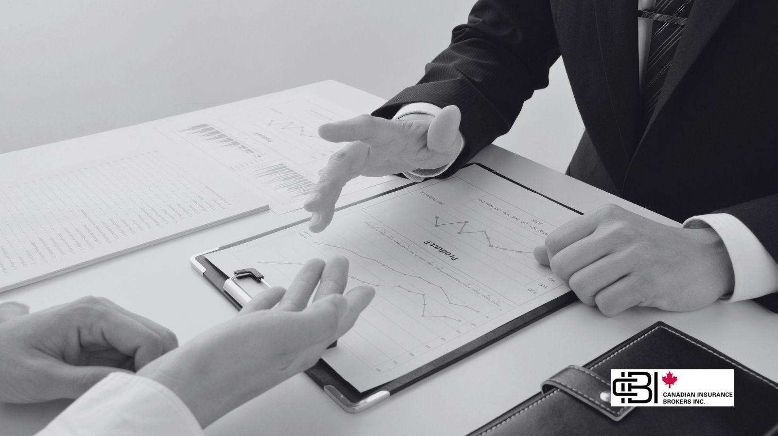 Business professionals discussing charts and strategy as part of planning How To Start a Consulting Business