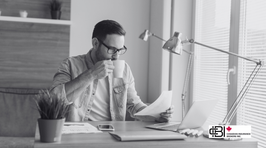 Freelancer reviewing paperwork and finances at home office, emphasizing freelancers insurance for income and liability protection