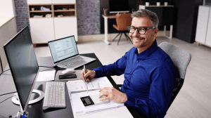 Professional accountant working with financial documents and calculator, illustrating accountant and tax preparer insurance protection