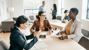 Accountants and tax professionals reviewing documents in a meeting, highlighting insurance solutions