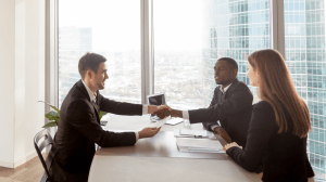 Recruitment professionals meeting with a client to finalize a candidate placement in a professional office setting in Oakville