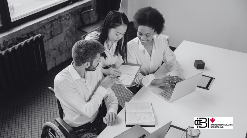 Insurance brokerage team reviewing insurance exclusions and policy details together at a laptop.