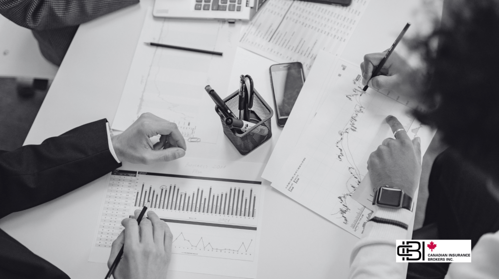 Business professionals reviewing financial reports, charts, and market data while developing an Ontario business plan and evaluating business performance