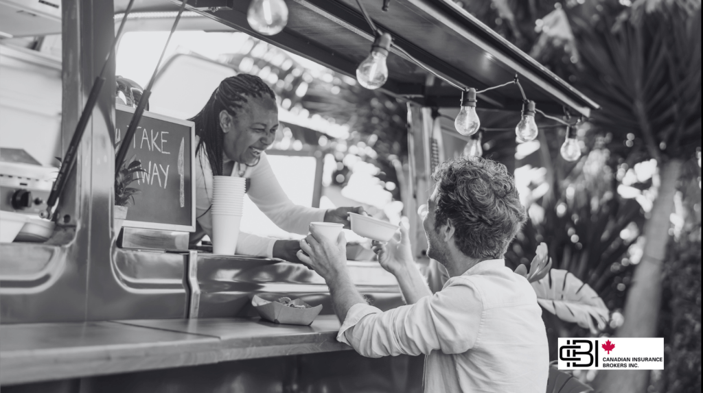 Food truck employee serving a customer through a service window, illustrating food truck insurance for Ontario businesses covering customer service, liability, and daily operations