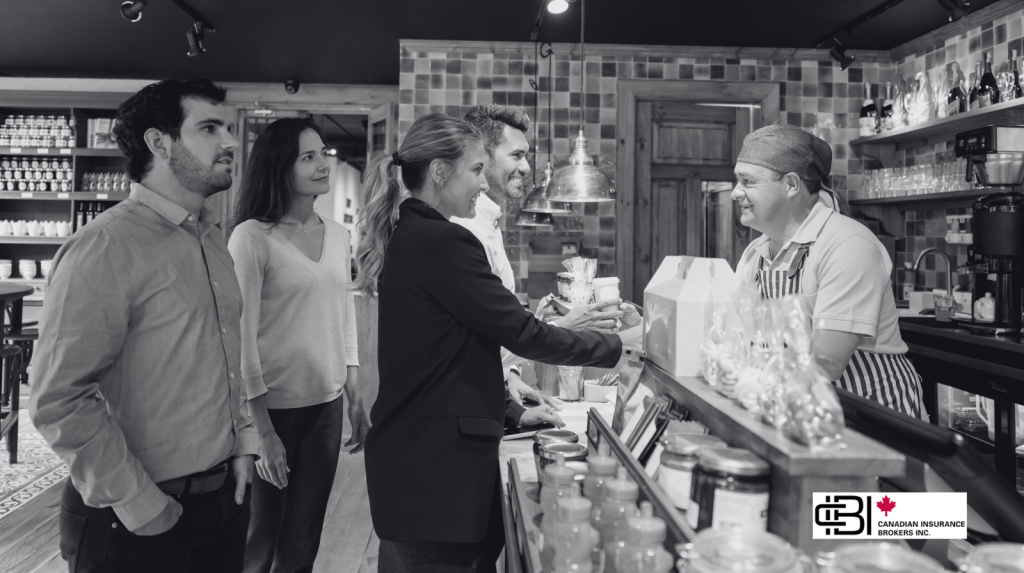 Prospective restaurant buyers meeting with the current owner at a restaurant counter while discussing the business purchase and operational details.
